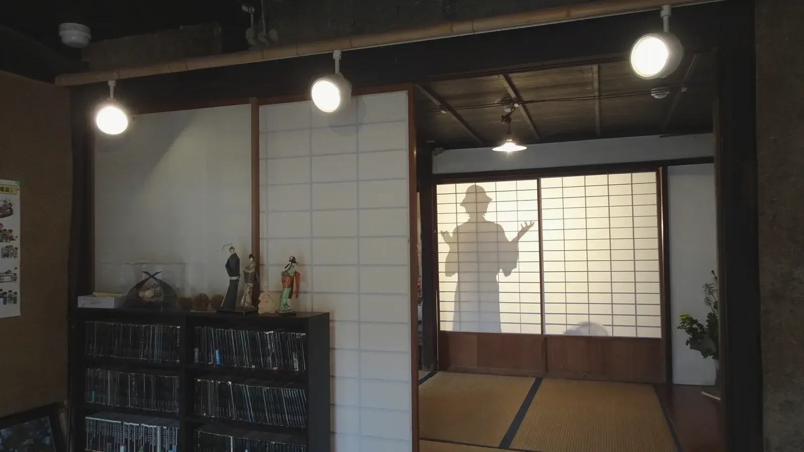 A tatami tea room, low table set beneath shoji light