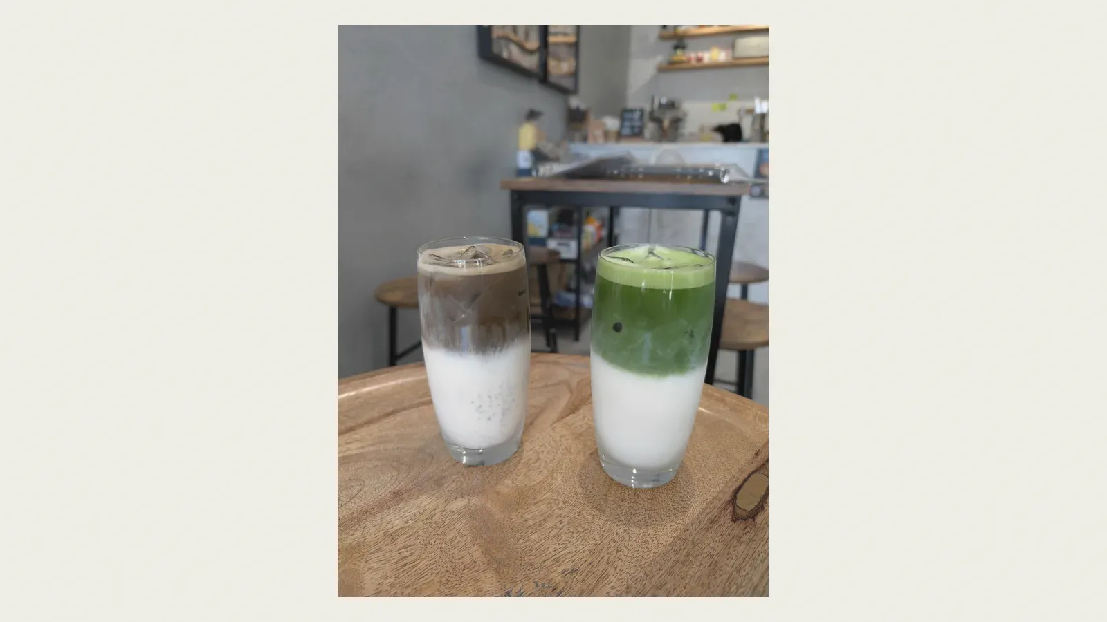 An iced hojicha latte and an iced matcha latte side by side, each layered brown or green over milk