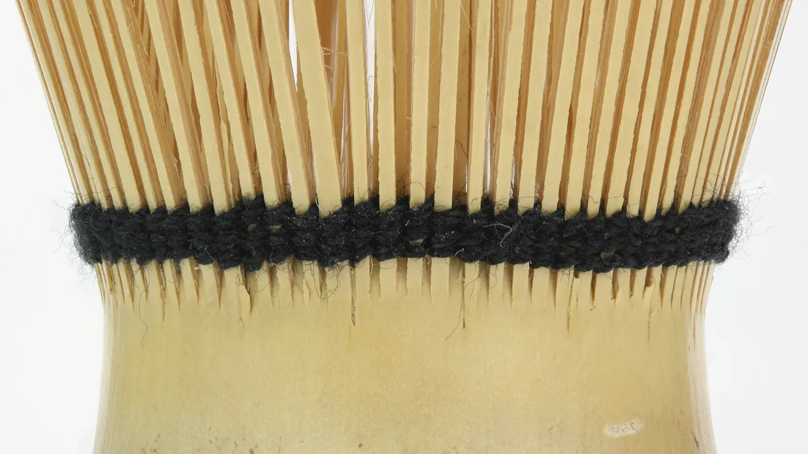 The split bamboo tines of a tea whisk in close detail