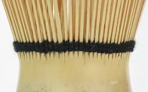 The split bamboo tines of a tea whisk in close detail